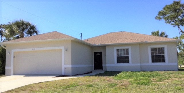 A two-story house with a garage on the left side.