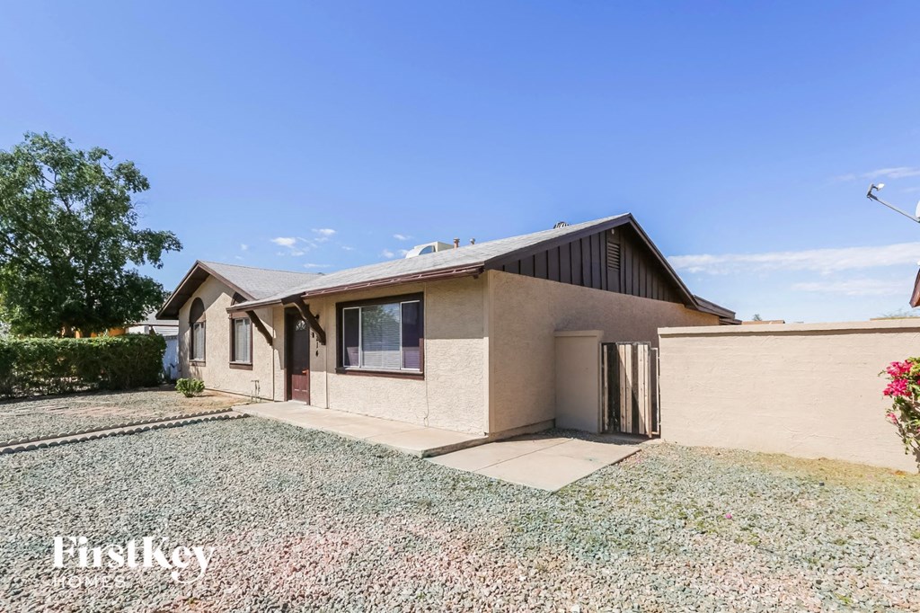 a house with a gravel yard and a driveway