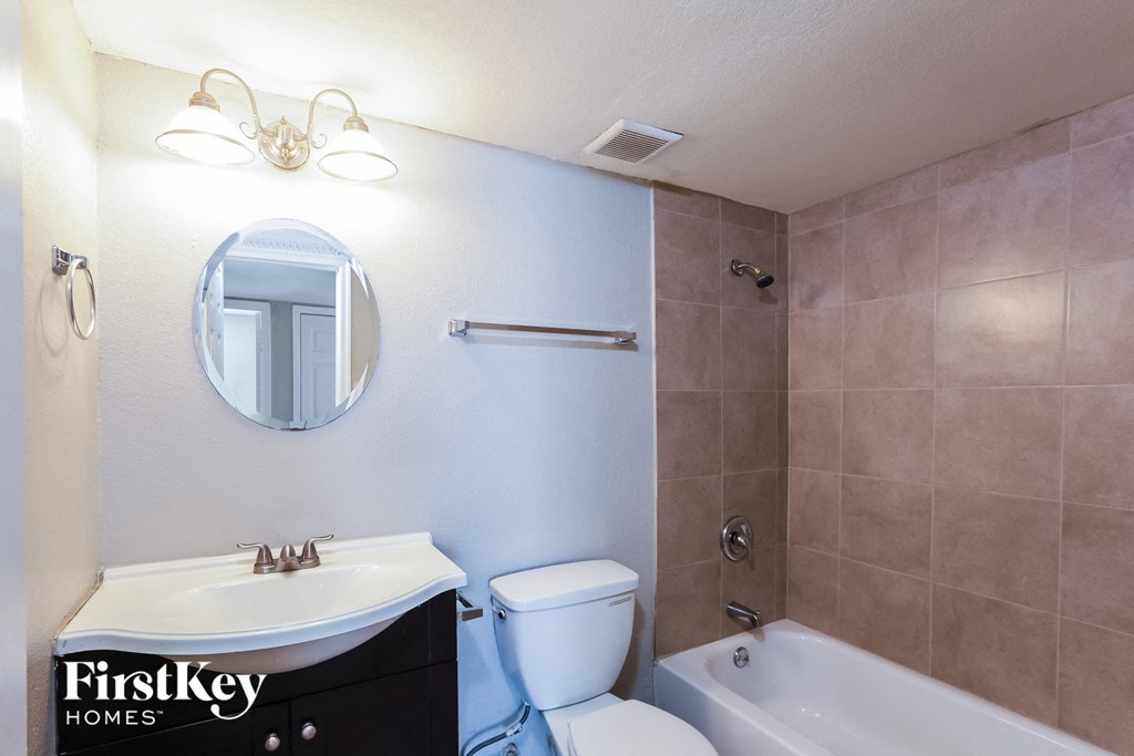 a bathroom with a sink toilet and a tub