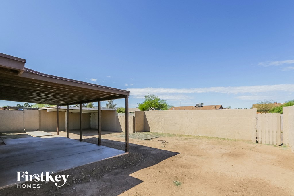 the backyard has a covered patio with a shade canopy