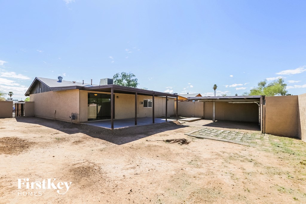 a home with a dirt yard and a house in the