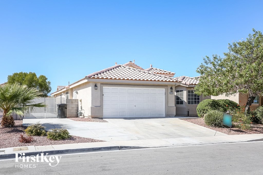 a home with a white garage door in front of a driveway