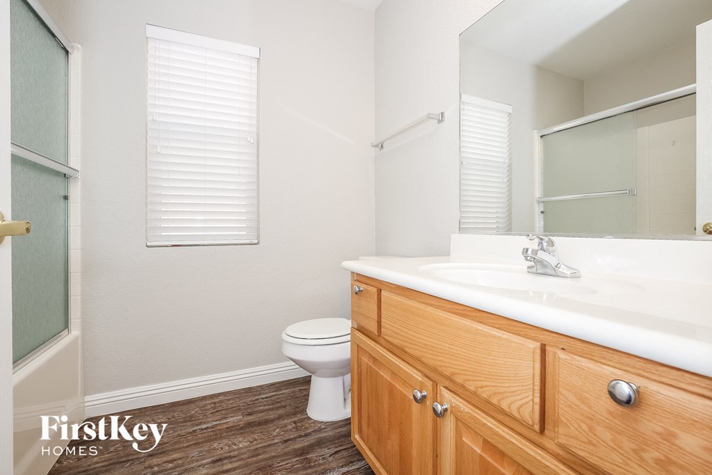 a bathroom with a toilet and a sink and a mirror