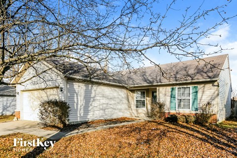 A house with a tree in front of it.
