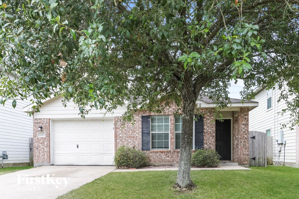 a white house with a tree in front of it