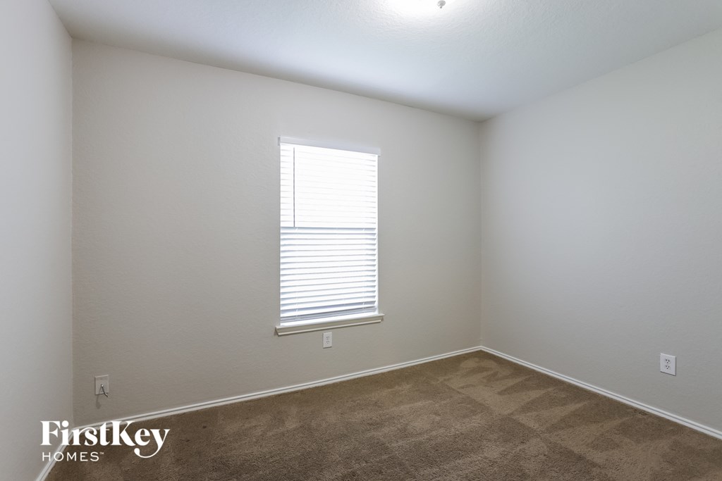 a room with a carpeted floor and a window