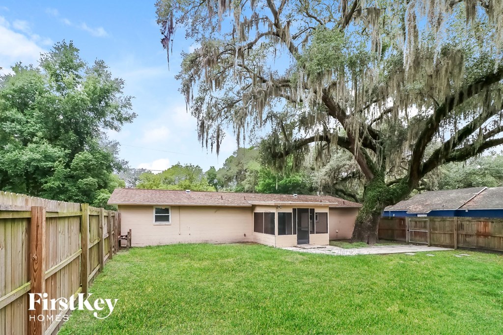 a small house with a yard and a tree