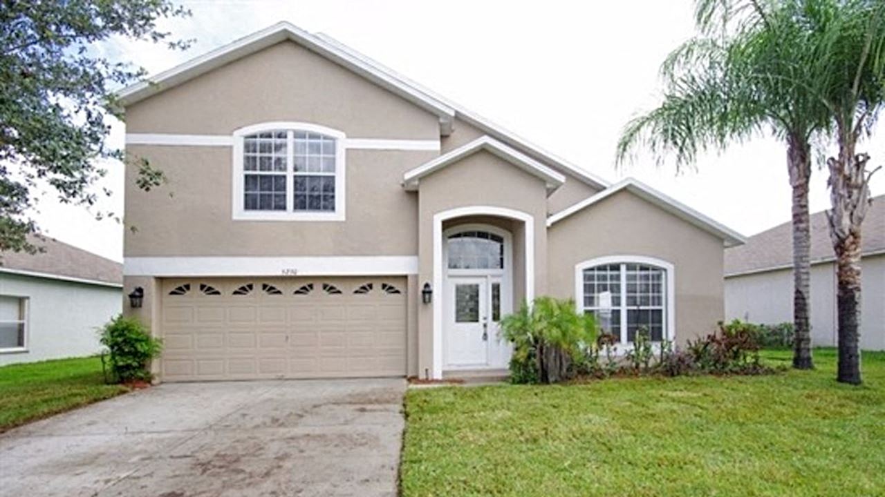 A house with a white garage door and a brown roof.
