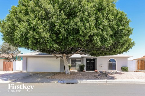 A house with a tree in front of it.