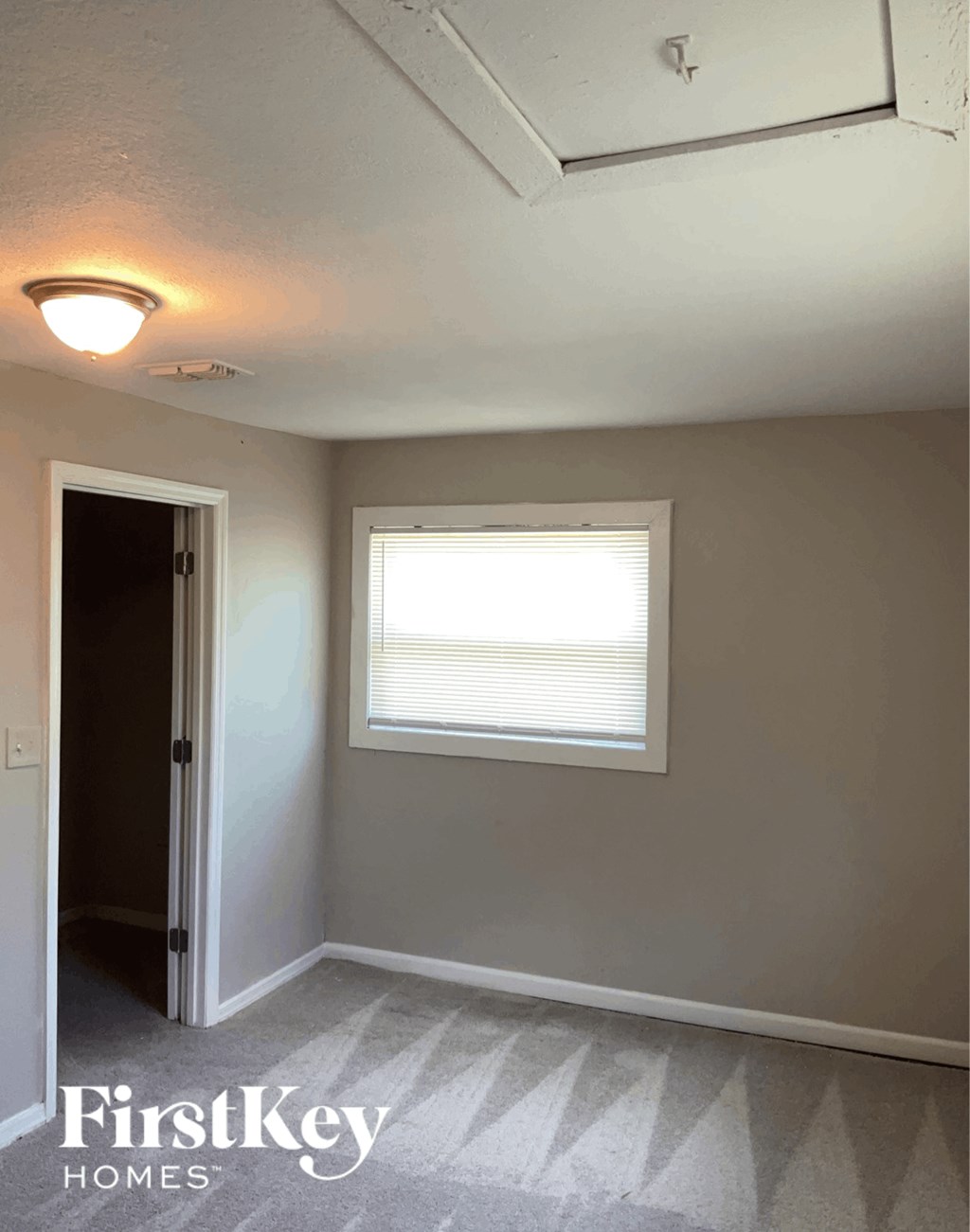 an empty room with a window and a door