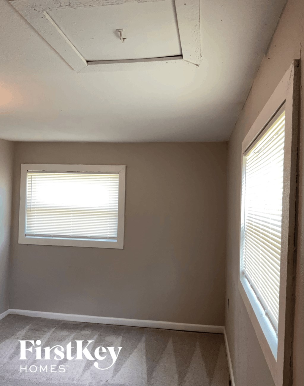 a small room with a window and a white ceiling