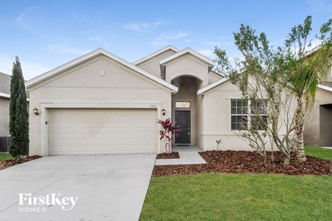 a white house with a driveway and a garage door
