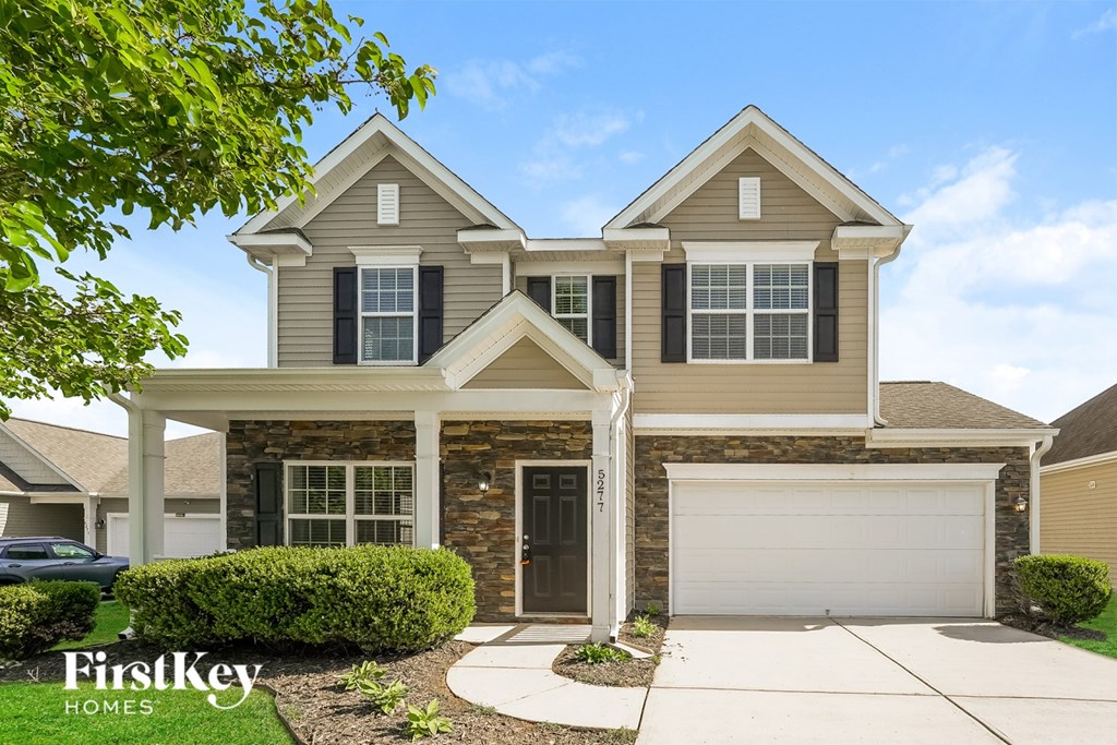 A two-story house with a garage is for sale by FirstKey Homes.