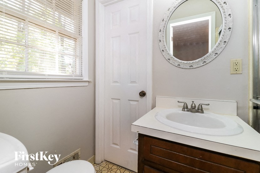 a small bathroom with a sink and a mirror