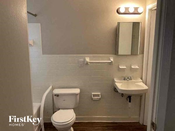 a white bathroom with a toilet and a sink