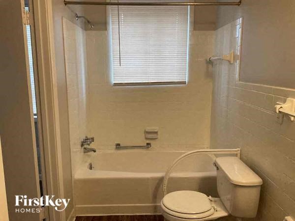 a bathroom with a toilet and a bath tub
