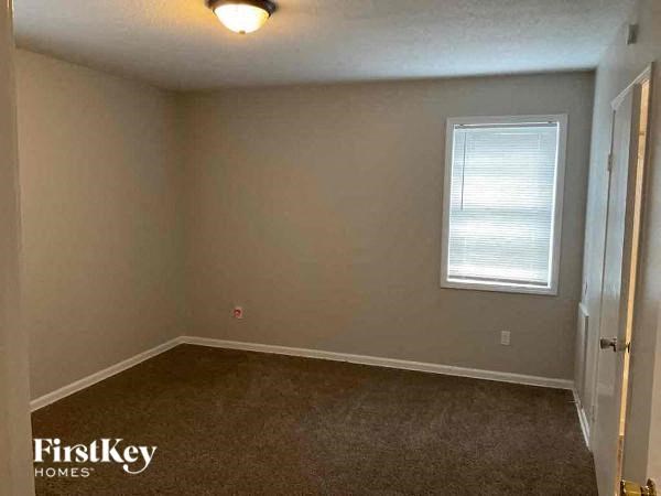 an empty room with a window and a door