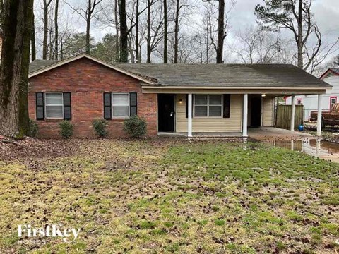 a small brick house in the middle of a flooded yard