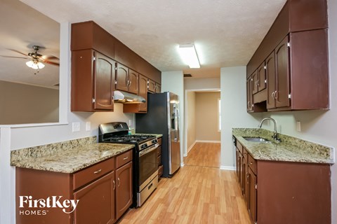 full view of kitchen with granite counter tops and stainless steel appliances