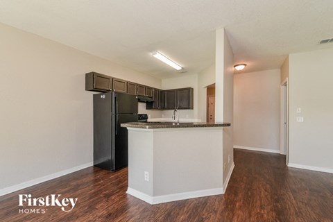 a kitchen with a counter top and a refrigerator