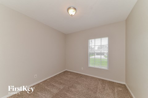 the second bedroom with carpet and a window