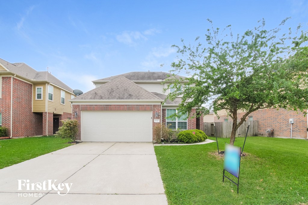 a house with a driveway and a garage door in front of it