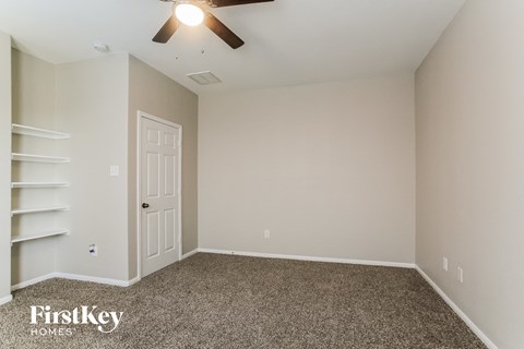 the upstairs bedroom has a closet and a ceiling fan