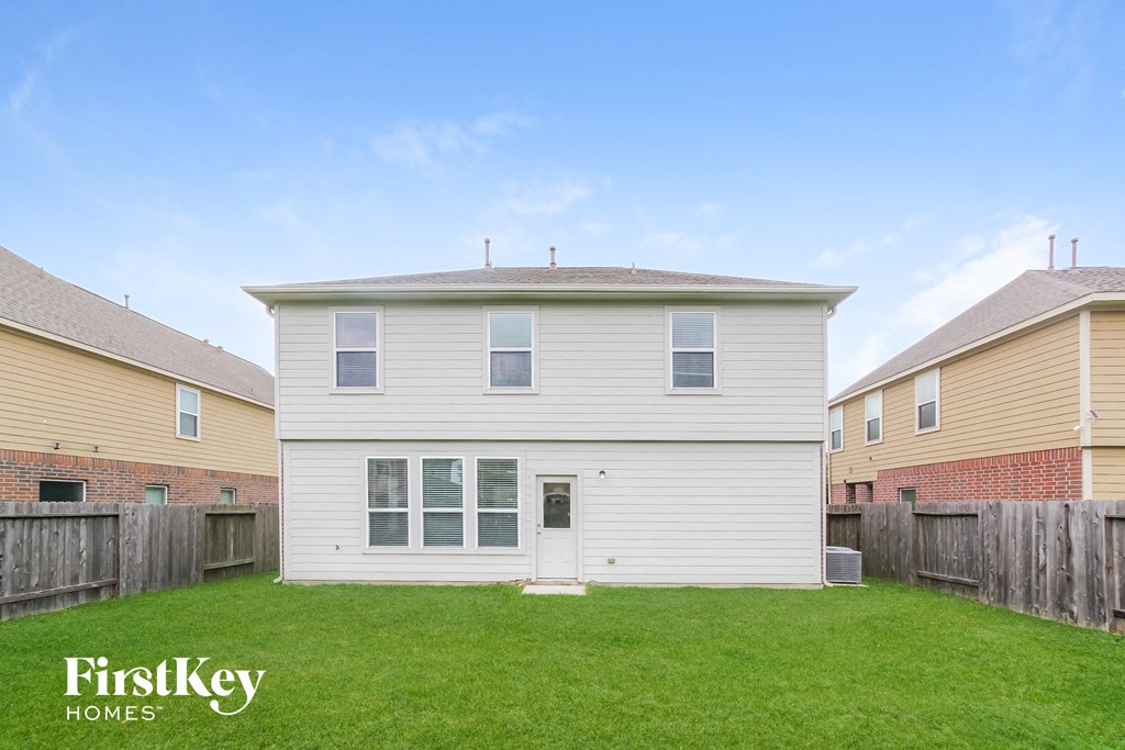 a white house with a yard in front of it
