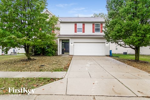 A house with a red and white garage door is for sale.
