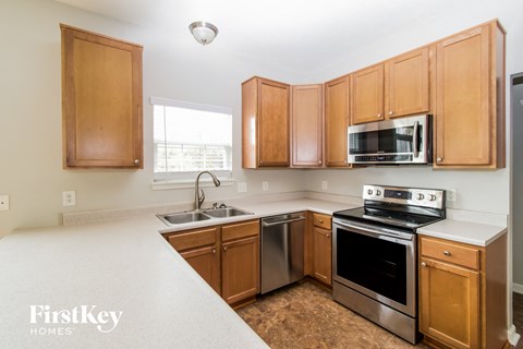 A kitchen with wooden cabinets and stainless steel appliances.