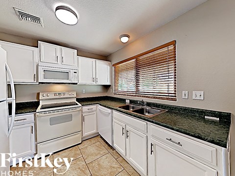 a white kitchen with white appliances and white cabinets