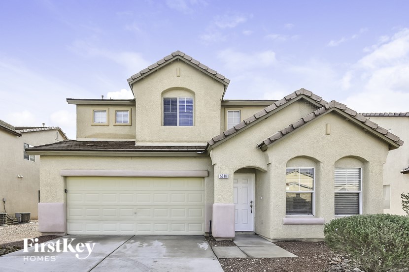 A two-story house with a garage is for sale.