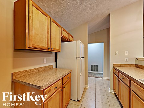 a kitchen with wooden cabinets and a refrigerator