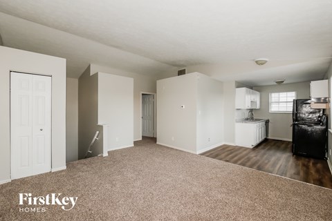 A spacious living room with a couch and a television.