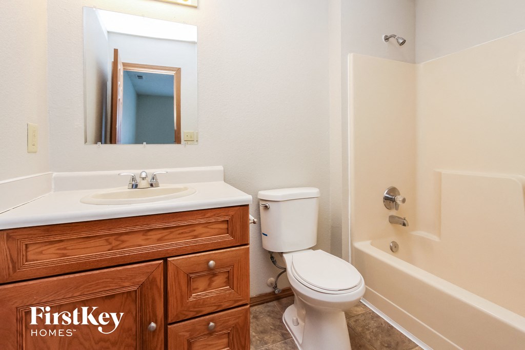 a bathroom with a toilet and a sink and a bath tub