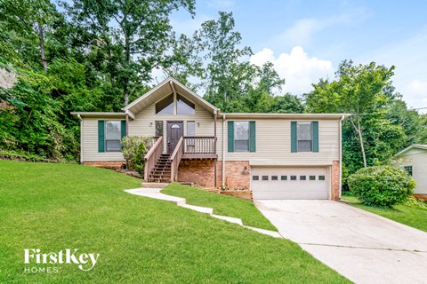 a house with a lawn and a driveway
