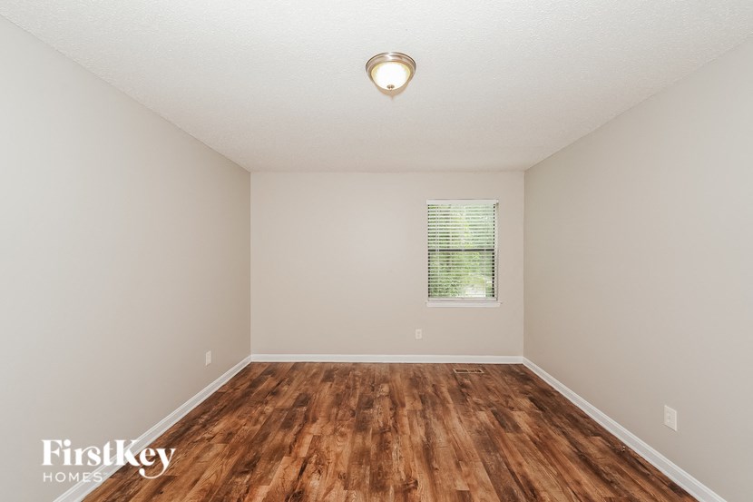 a room with a hard wood floor and a window