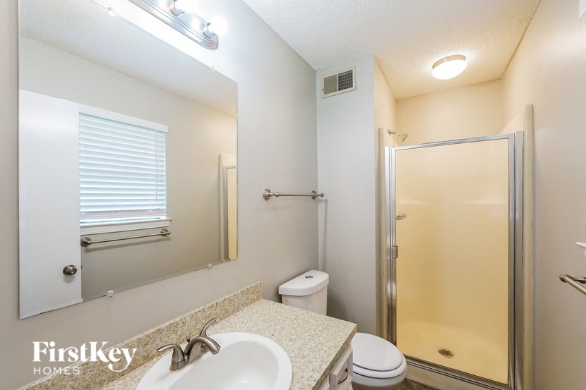 a bathroom with a sink toilet and a shower