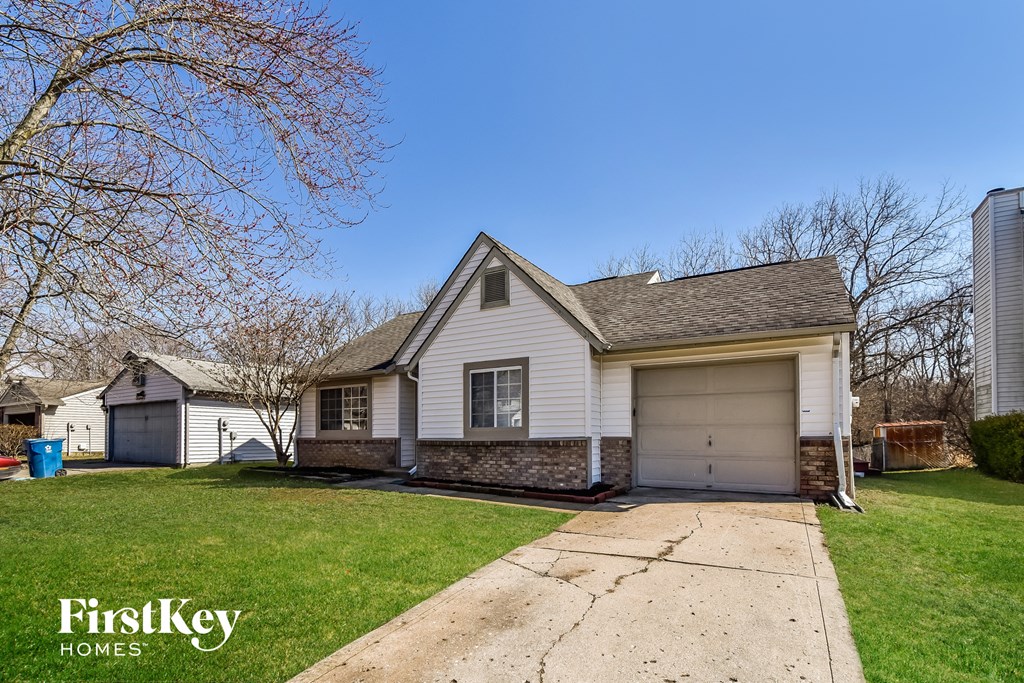 a white house with a driveway and a garage door