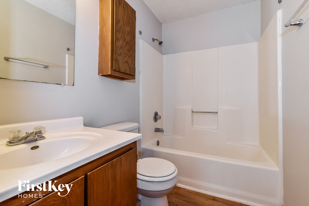 a bathroom with a sink toilet and a bath tub