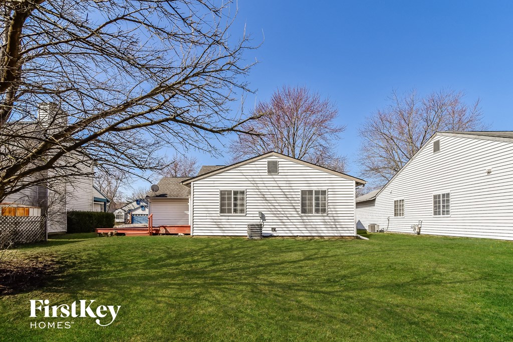a white house with a yard and a blue sky