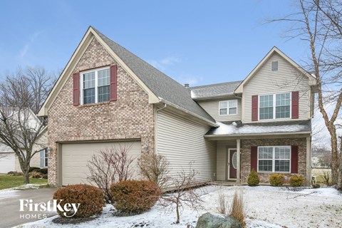 full view of home with snow on the ground