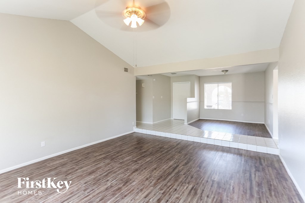 A room with wooden flooring and a light fixture on the ceiling.