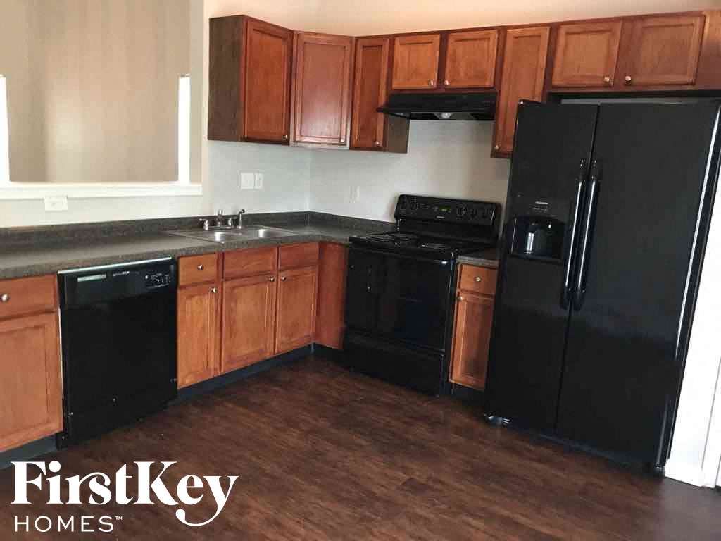 a kitchen with black appliances and wooden cabinets
