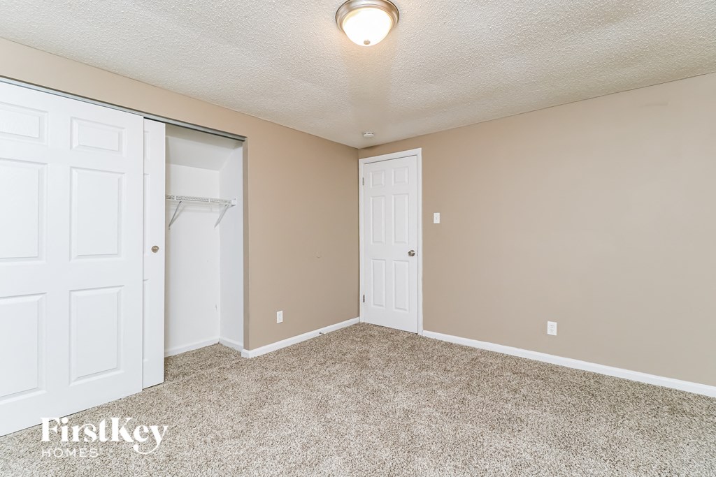 a bedroom with two closets and a door to a closet