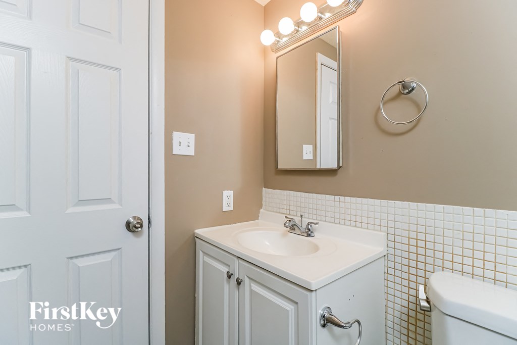 a bathroom with a sink and a mirror and a toilet