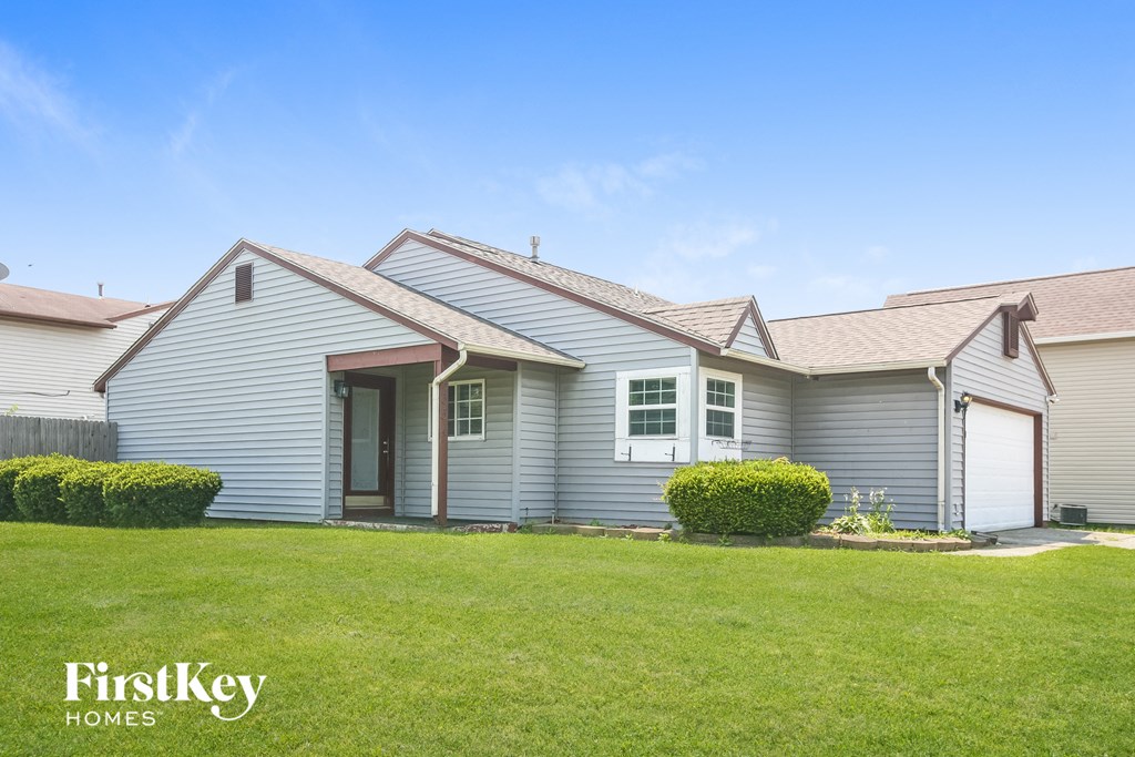 a white house with a lawn in front of it