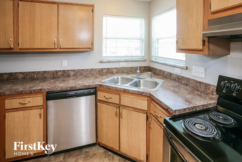 a kitchen with wooden cabinets and stainless steel appliances and a counter top