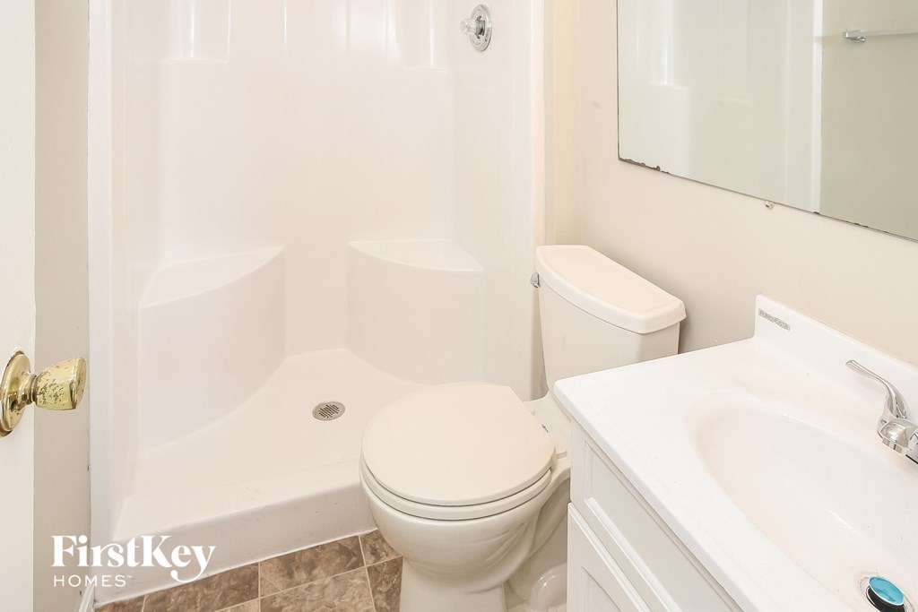 a bathroom with a toilet and a tub and a sink