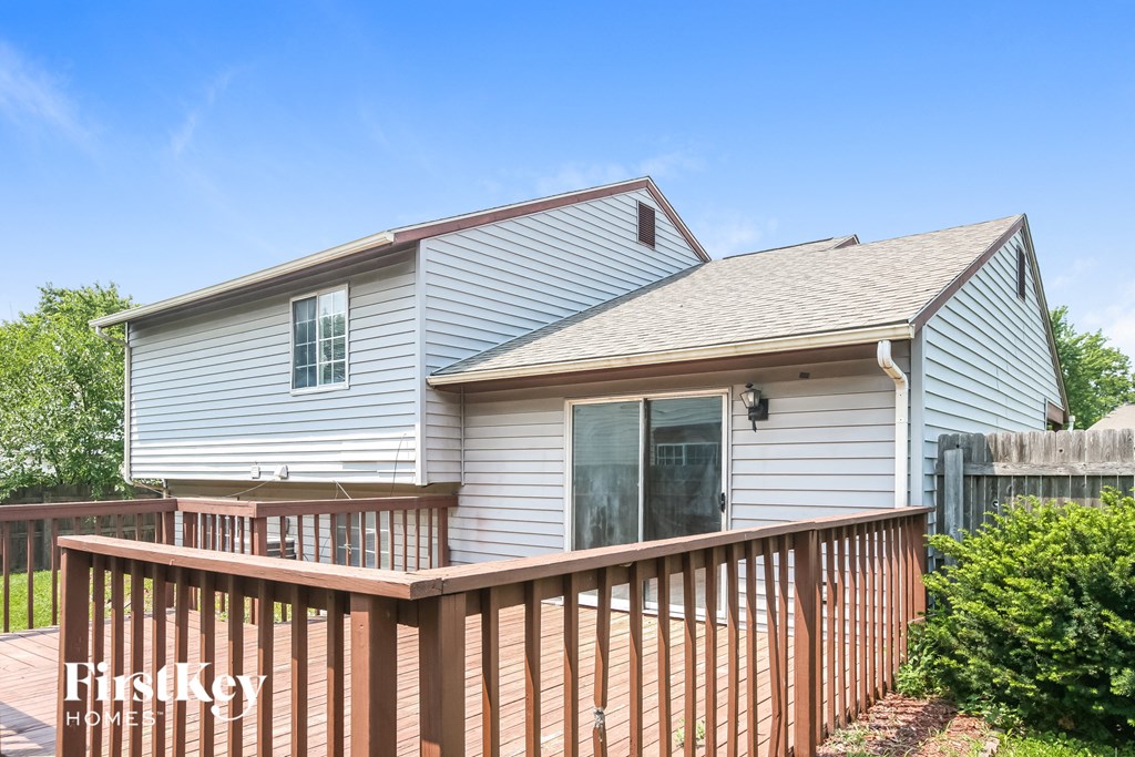 a white house with a wooden fence in front of it